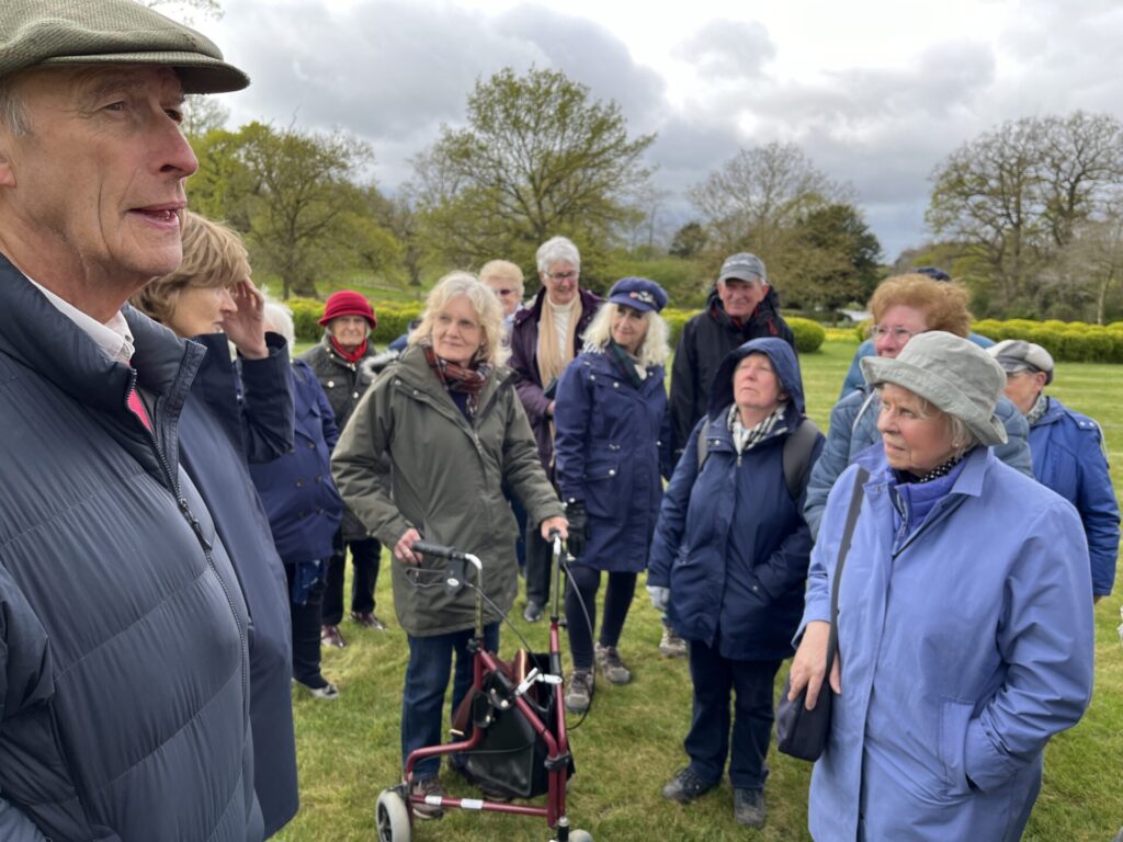 Garden Group members listen to the owner and his wife at Holme Hale, Group Leader Lesley Bishop in centre