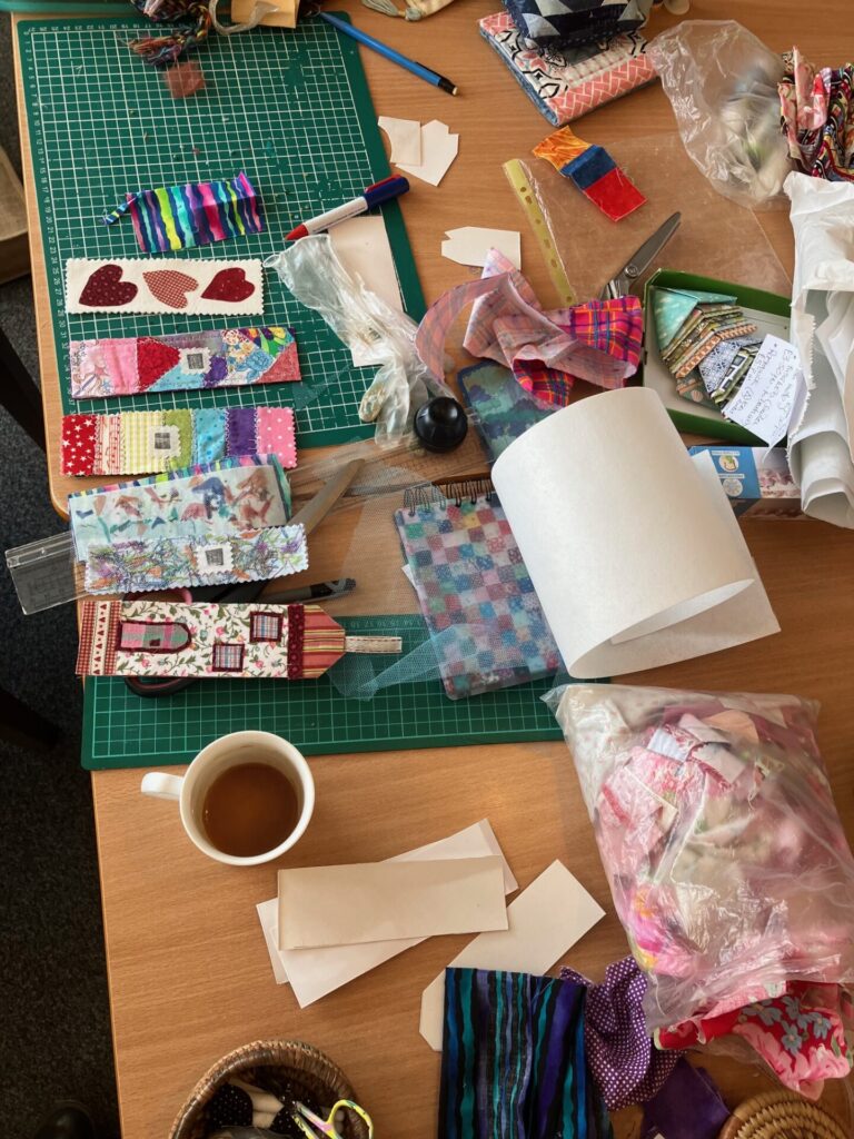 Fabrics,  cutting mats and important coffee cups  ready for the session.
